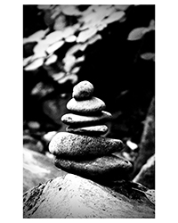 Black and white photo of a stack of rocks. Photo taken by Austin Metzger